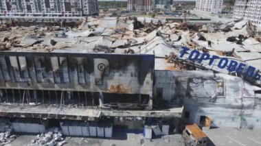 This stock video shows a destroyed building of a shopping center in Bucha, Ukraine during the war in 8K resolution
