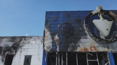 This stock video shows a destroyed building of a shopping center in Bucha, Ukraine during the war in 8K resolution
