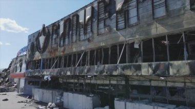 This stock video shows a destroyed building of a shopping center in Bucha, Ukraine during the war in 8K resolution