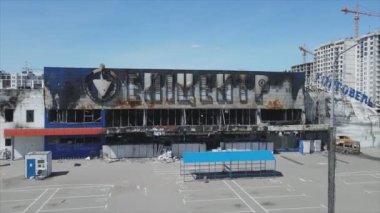 This stock video shows a destroyed building of a shopping center in Bucha, Ukraine during the war in 8K resolution