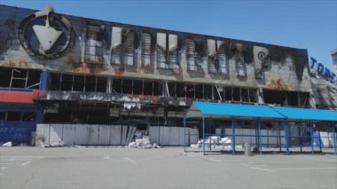 This stock video shows a destroyed building of a shopping center in Bucha, Ukraine during the war in 8K resolution