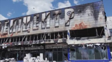 This stock video shows a destroyed building of a shopping center in Bucha, Ukraine during the war in 8K resolution
