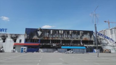 This stock video shows a destroyed building of a shopping center in Bucha, Ukraine during the war in 8K resolution