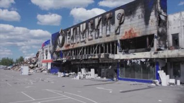 This stock video shows a destroyed building of a shopping center in Bucha, Ukraine during the war in 8K resolution