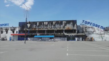 This stock video shows a destroyed building of a shopping center in Bucha, Ukraine during the war in 8K resolution