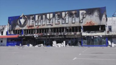 This stock video shows a destroyed building of a shopping center in Bucha, Ukraine during the war in 8K resolution