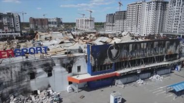 This stock video shows a destroyed building of a shopping center in Bucha, Ukraine during the war in 8K resolution