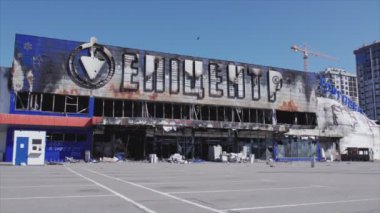 This stock video shows a destroyed building of a shopping center in Bucha, Ukraine during the war in 8K resolution