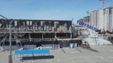 This stock video shows a destroyed building of a shopping center in Bucha, Ukraine during the war in 8K resolution