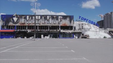 This stock video shows a destroyed building of a shopping center in Bucha, Ukraine during the war in 8K resolution