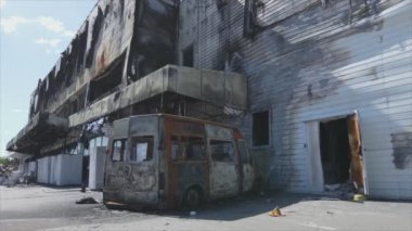 This stock video shows a destroyed building of a shopping center in Bucha, Ukraine during the war in 8K resolution