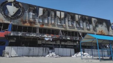 This stock video shows a destroyed building of a shopping center in Bucha, Ukraine during the war in 8K resolution