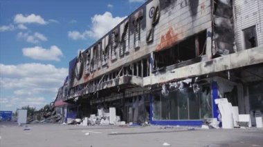 This stock video shows a destroyed building of a shopping center in Bucha, Ukraine during the war in 8K resolution