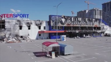 This stock video shows a destroyed building of a shopping center in Bucha, Ukraine during the war in 8K resolution