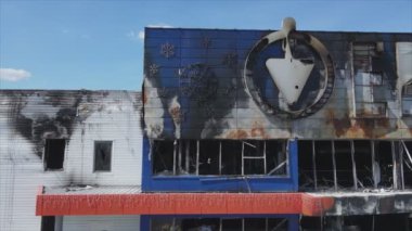 This stock video shows a destroyed building of a shopping center in Bucha, Ukraine during the war in 8K resolution