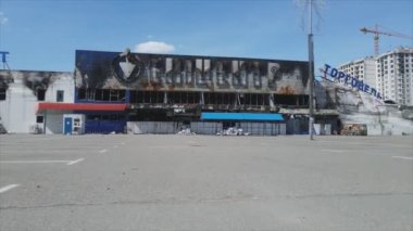 This stock video shows a destroyed building of a shopping center in Bucha, Ukraine during the war in 8K resolution