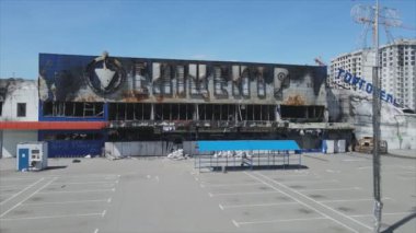 This stock video shows a destroyed building of a shopping center in Bucha, Ukraine during the war in 8K resolution