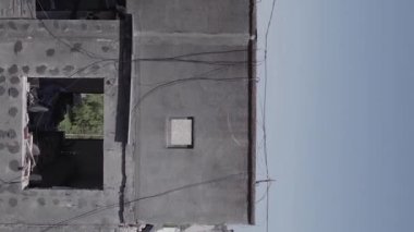 This stock vertical video shows the aftermath of the war in Ukraine - a destroyed residential building in Borodyanka, grey, flat video