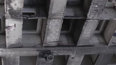 This stock vertical video shows the aftermath of the war in Ukraine - a destroyed residential building in Borodyanka, grey, flat video