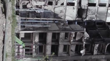 This stock vertical video shows the aftermath of the war in Ukraine - a destroyed residential building in Borodyanka, grey, flat video