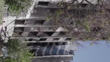 This stock vertical video shows the aftermath of the war in Ukraine - a destroyed residential building in Borodyanka, grey, flat video