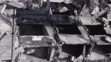 This stock vertical video shows the aftermath of the war in Ukraine - a destroyed residential building in Borodyanka, grey, flat video