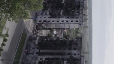 This stock vertical video shows the aftermath of the war in Ukraine - a destroyed residential building in Borodyanka, grey, flat video