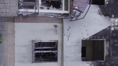 This stock vertical video shows the aftermath of the war in Ukraine - a destroyed residential building in Borodyanka, grey, flat video