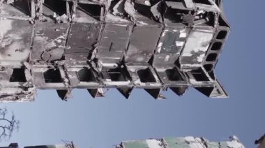 This stock vertical video shows the aftermath of the war in Ukraine - a destroyed residential building in Borodyanka, grey, flat video