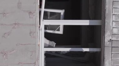 This stock vertical video shows the aftermath of the war in Ukraine - a destroyed residential building in Borodyanka, grey, flat video