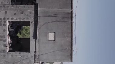 This stock vertical video shows the aftermath of the war in Ukraine - a destroyed residential building in Borodyanka, grey, flat video