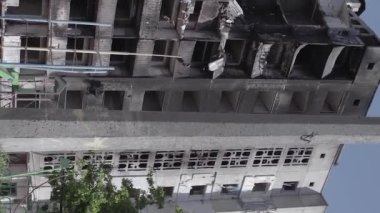 This stock vertical video shows the aftermath of the war in Ukraine - a destroyed residential building in Borodyanka, grey, flat video