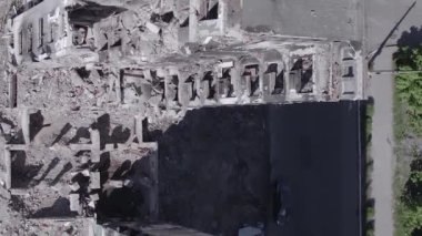 This stock vertical video shows the aftermath of the war in Ukraine - a destroyed residential building in Borodyanka, grey, flat video