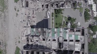 This stock vertical video shows the aftermath of the war in Ukraine - a destroyed residential building in Borodyanka, grey, flat video