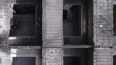 This stock vertical video shows the aftermath of the war in Ukraine - a destroyed residential building in Borodyanka, grey, flat video