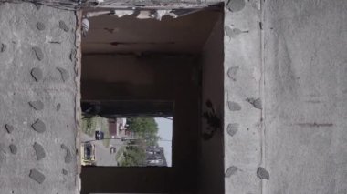 This stock vertical video shows the aftermath of the war in Ukraine - a destroyed residential building in Borodyanka, grey, flat video