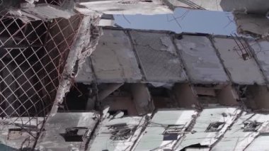 This stock vertical video shows the aftermath of the war in Ukraine - a destroyed residential building in Borodyanka, grey, flat video