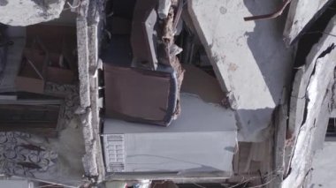 This stock vertical video shows the aftermath of the war in Ukraine - a destroyed residential building in Borodyanka, grey, flat video
