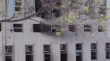 This stock vertical video shows the aftermath of the war in Ukraine - a destroyed residential building in Borodyanka, grey, flat video