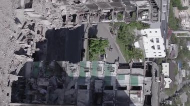 This stock vertical video shows the aftermath of the war in Ukraine - a destroyed residential building in Borodyanka, grey, flat video