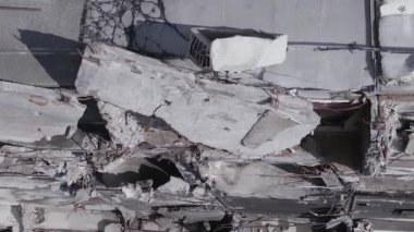 This stock vertical video shows the aftermath of the war in Ukraine - a destroyed residential building in Borodyanka, grey, flat video