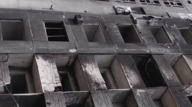 This stock vertical video shows the aftermath of the war in Ukraine - a destroyed residential building in Borodyanka, grey, flat video