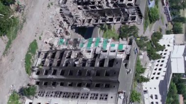 This stock vertical video shows the aftermath of the war in Ukraine - a destroyed residential building in Borodyanka, grey, flat video