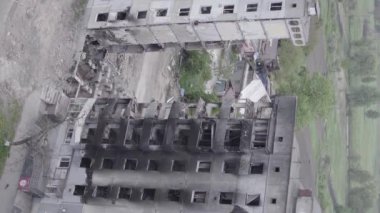 This stock vertical video shows the aftermath of the war in Ukraine - a destroyed residential building in Borodyanka, grey, flat video