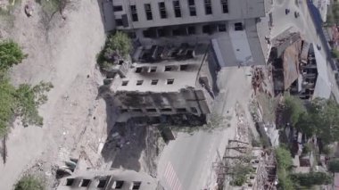 This stock vertical video shows the aftermath of the war in Ukraine - a destroyed residential building in Borodyanka, grey, flat video