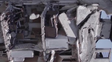 This stock vertical video shows the aftermath of the war in Ukraine - a destroyed residential building in Borodyanka, grey, flat video