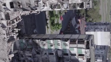 This stock vertical video shows the aftermath of the war in Ukraine - a destroyed residential building in Borodyanka, grey, flat video