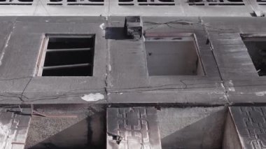 This stock vertical video shows the aftermath of the war in Ukraine - a destroyed residential building in Borodyanka, grey, flat video