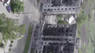 This stock vertical video shows the aftermath of the war in Ukraine - a destroyed residential building in Borodyanka, grey, flat video