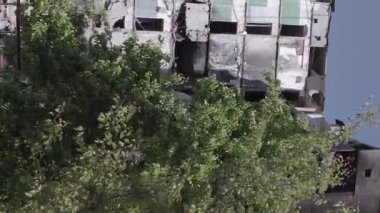 This stock vertical video shows the aftermath of the war in Ukraine - a destroyed residential building in Borodyanka, grey, flat video